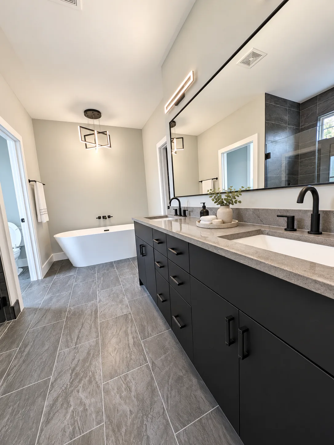 Black double vanity carrying the look into the master bath