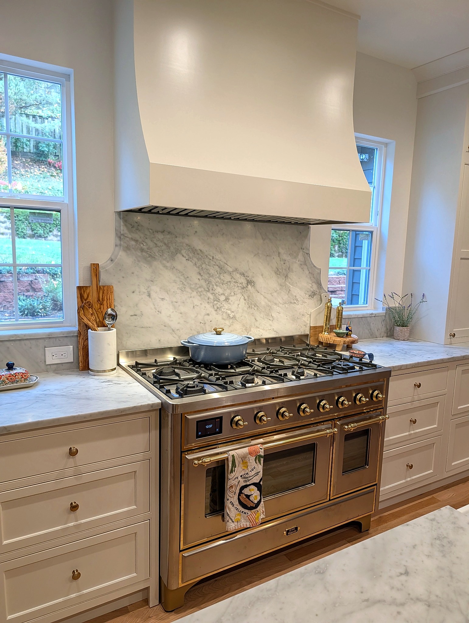 Brass range with marble slab backsplash