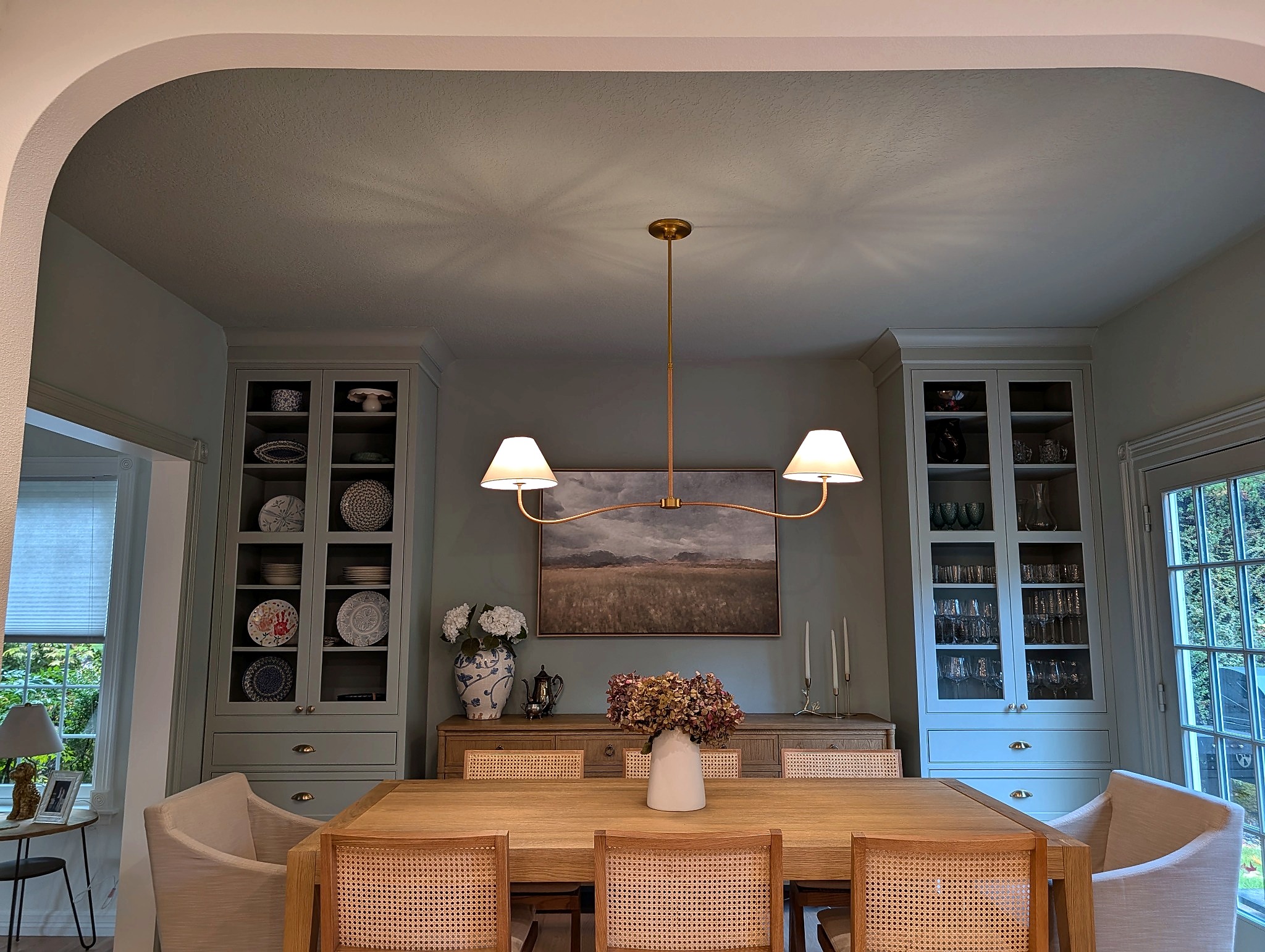 Dining room with custom Crystal Fog hutch through the arched opening