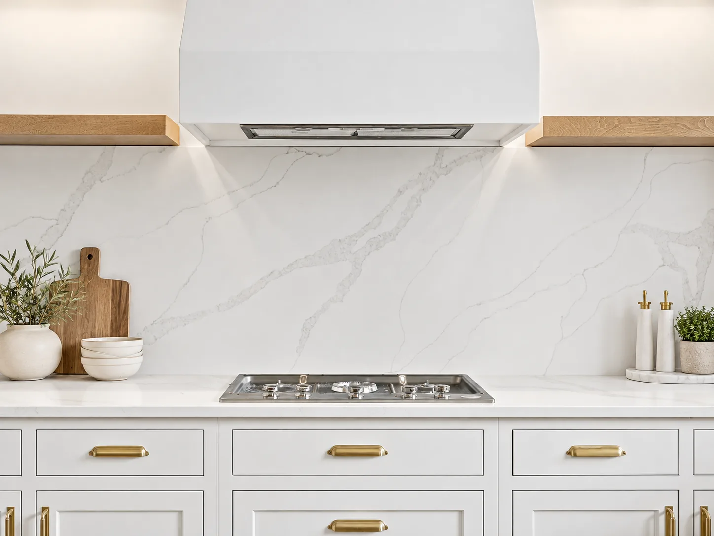 Custom hood over the range with slab backsplash, Artisan inset in Pure White