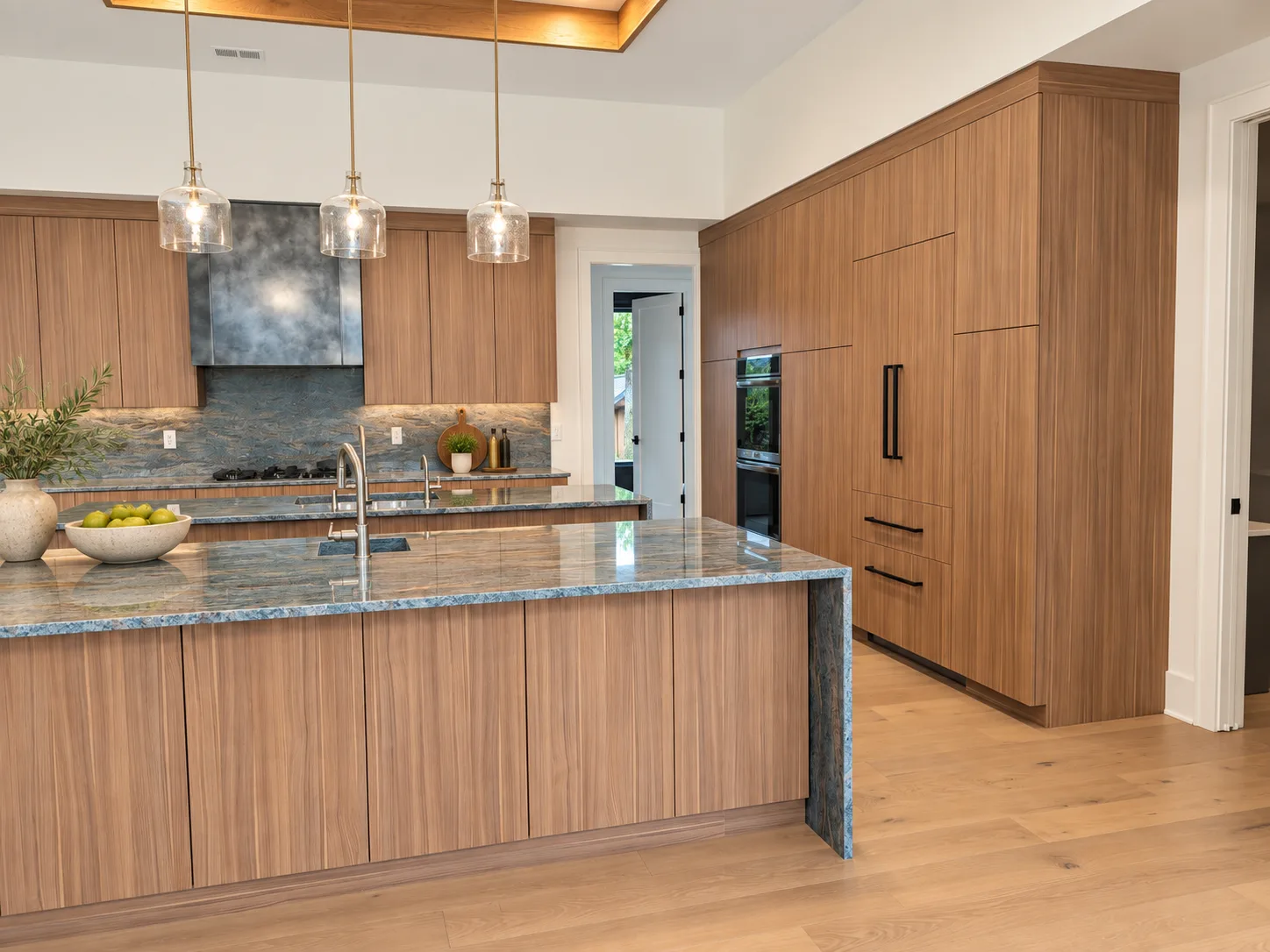 Eclipse kitchen in Arizona Cypress with stone hood wall and island