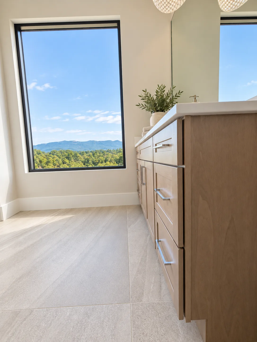 Evereve vanity beside a floor-to-ceiling mountain view window