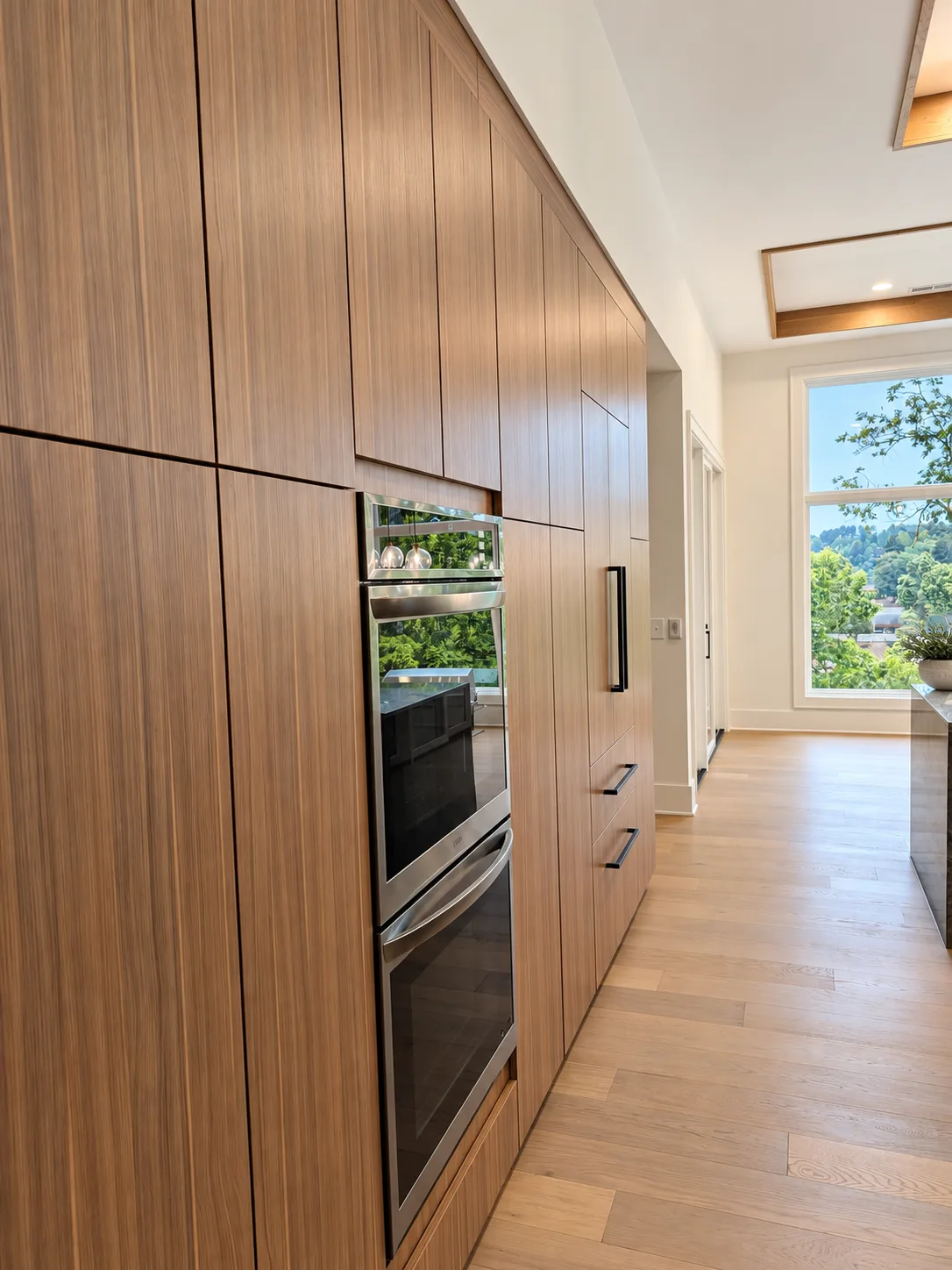 Grain-matched wall with flush ovens and custom panelized refrigerator
