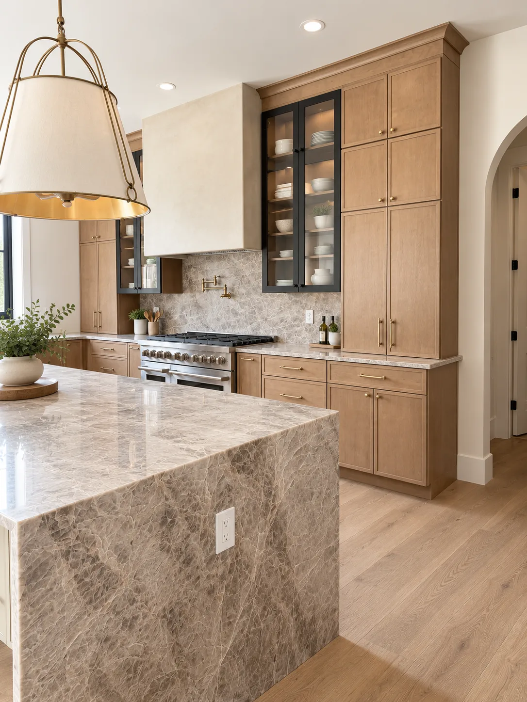 Stone waterfall island with Shaye cabinetry beyond