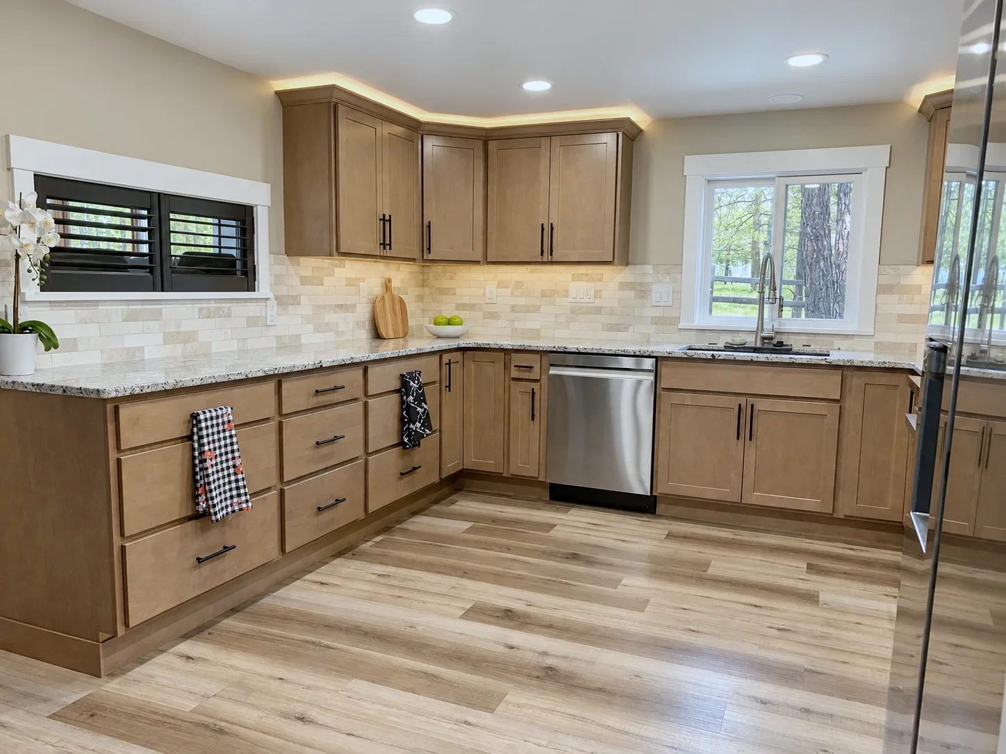 Sink window corner with Bristol doors in Element on Maple and travertine backsplash, Colorado Springs remodel