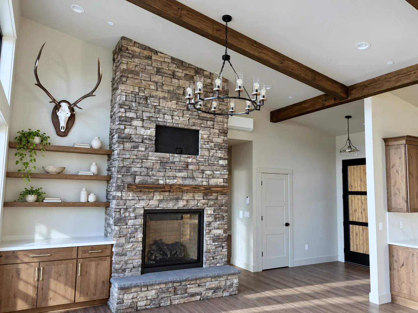 Stone fireplace with rustic alder built-ins and floating shelves, Everett WA custom home great room