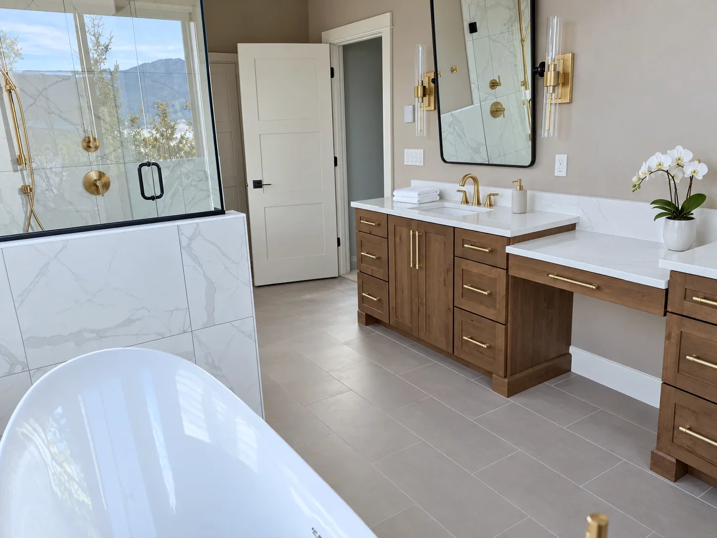 Primary bath with Prairie stained alder vanity, brass fixtures and freestanding tub, Everett WA custom home