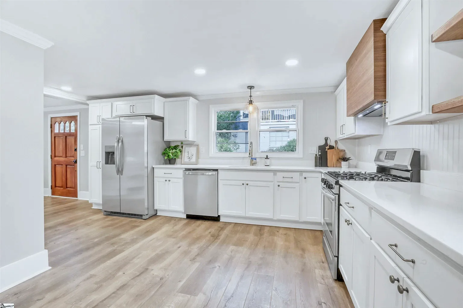 White Bristol kitchen in Alabaster with stainless appliances and wood floors, South Carolina contractor remodel