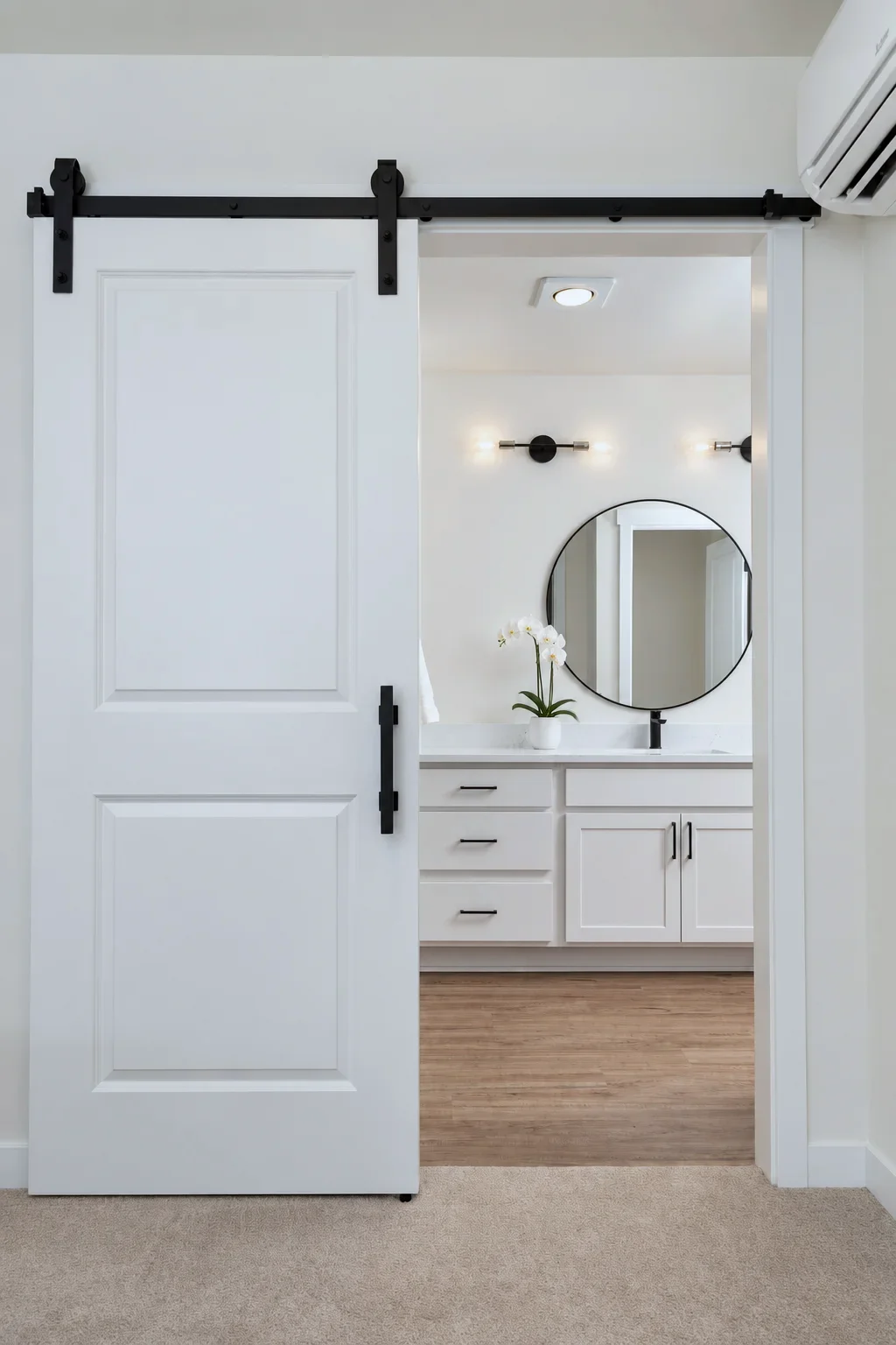 Barn door opening to a Bristol vanity in Alabaster, Kennewick WA spec home