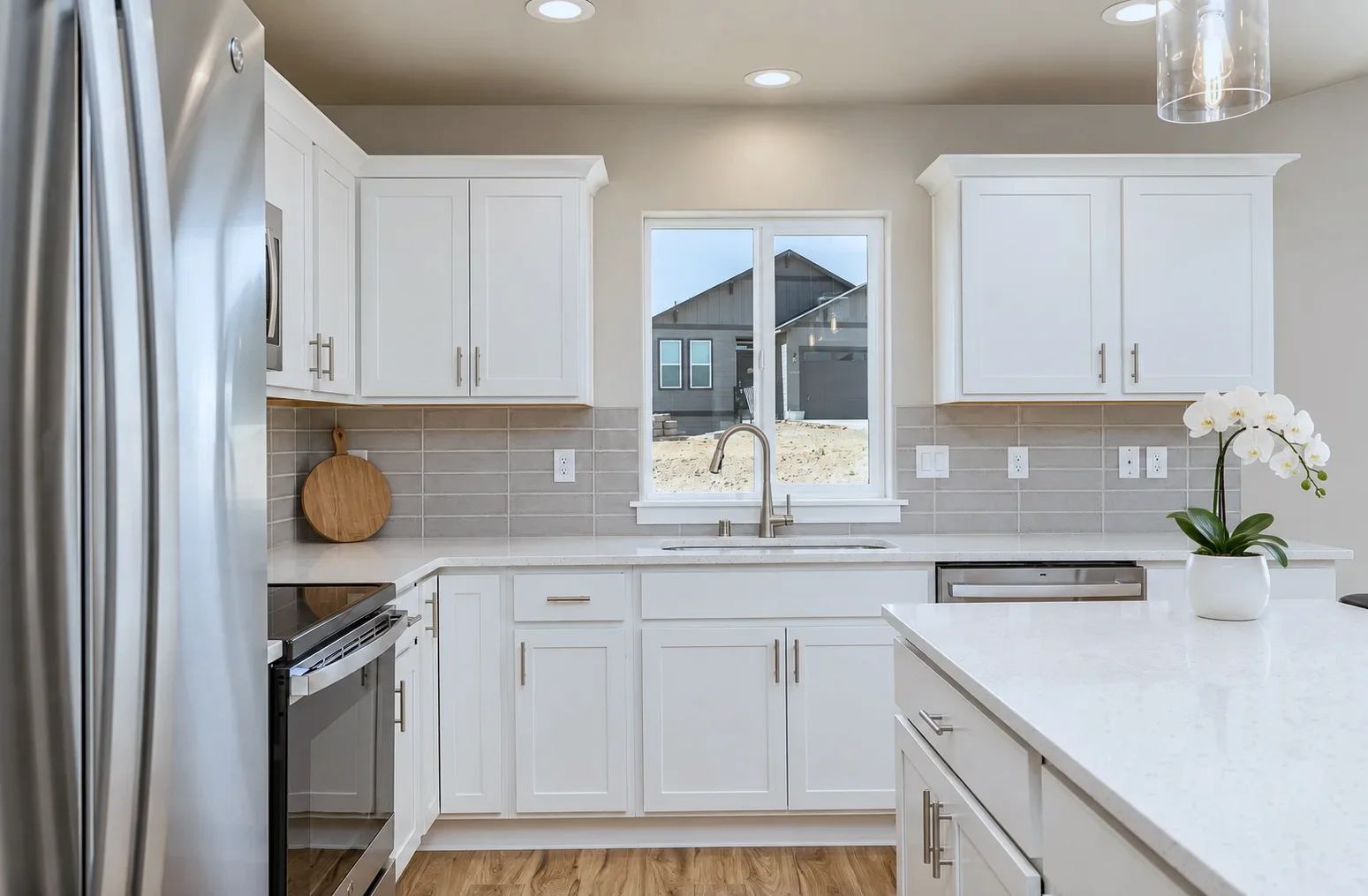 Kitchen sink window run with Bristol doors in Alabaster and gray subway tile, Kennewick WA spec home
