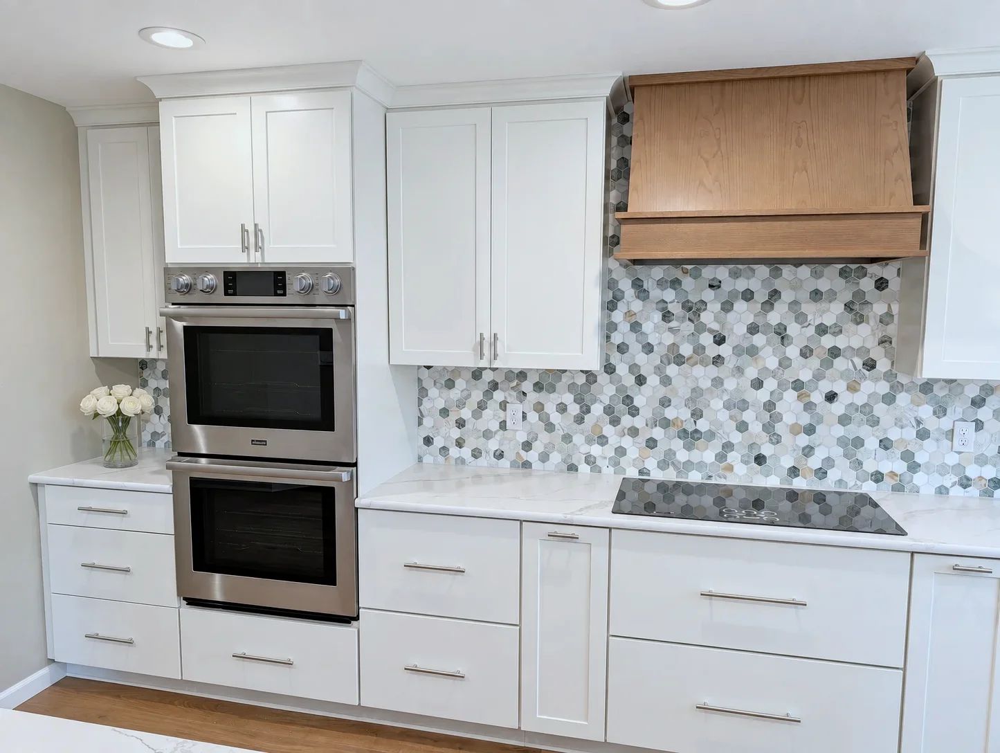 Double oven wall with Blond Evereve cabinets and oak hood over the cooktop, Oregon remodel