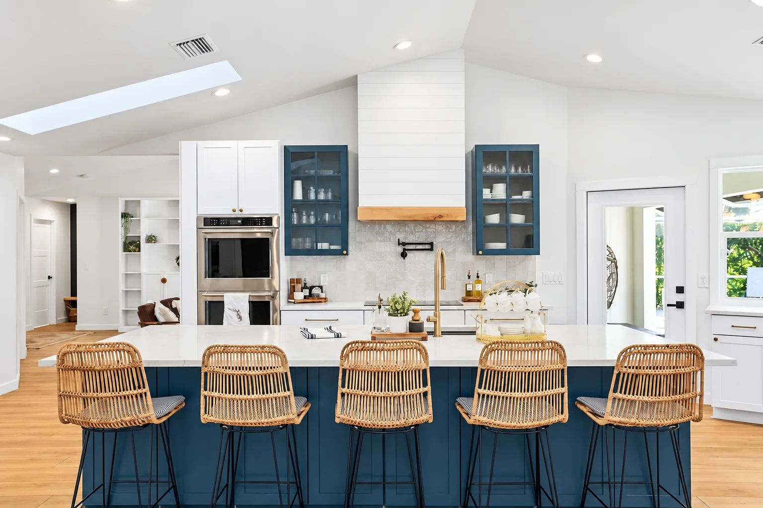 Navy kitchen island with rattan counter stools and white quartz, Sarasota remodel