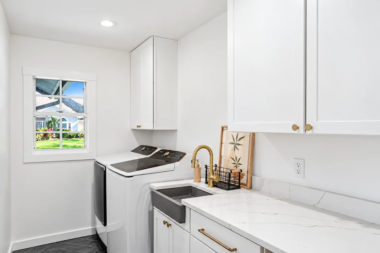 Laundry room with white cabinets, farmhouse sink and brass faucet, Sarasota remodel